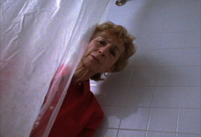A woman peaking behind a shower courtain