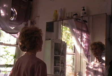 A woman talking into a mirror